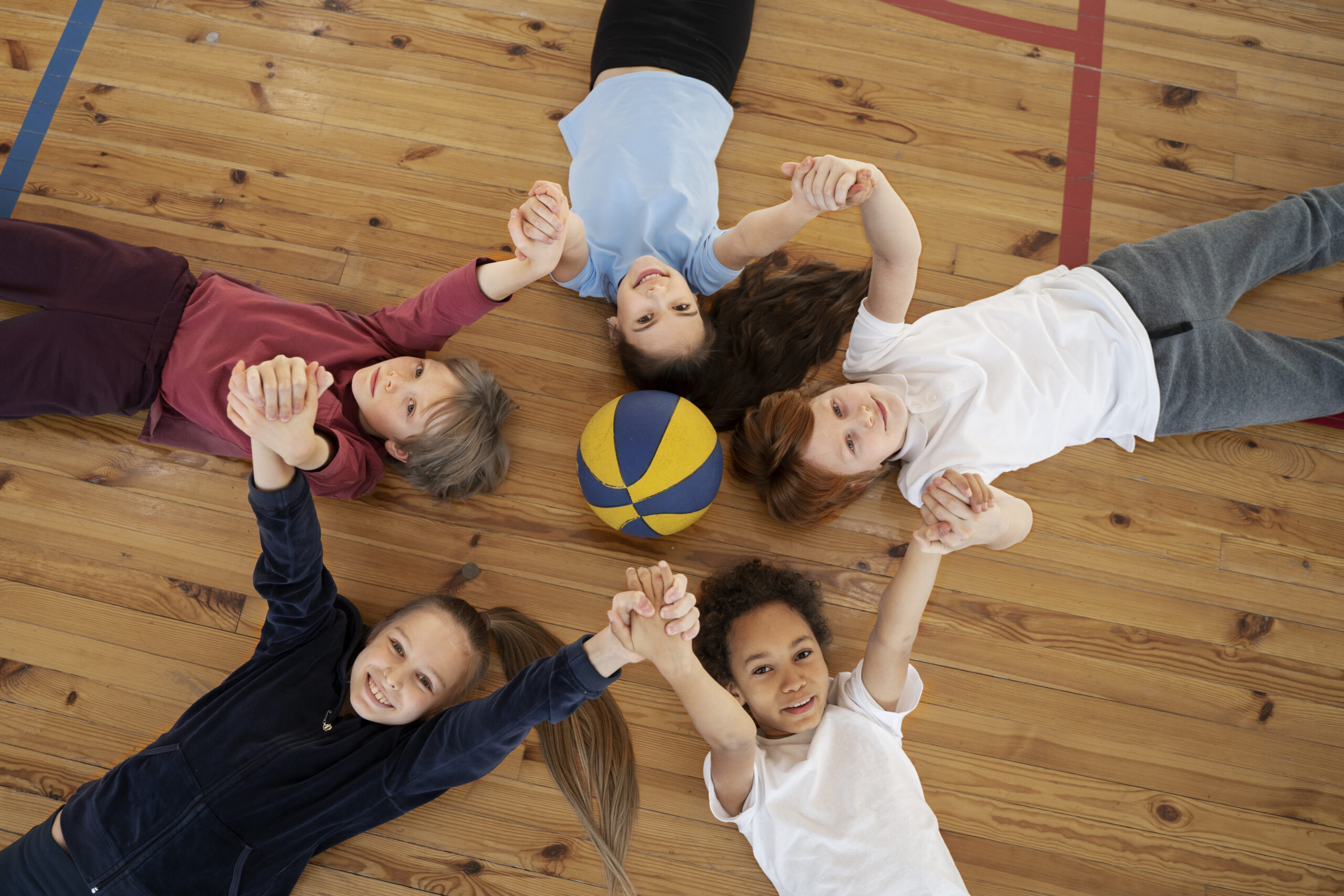 medium-shot-kids-laying-gym-floor